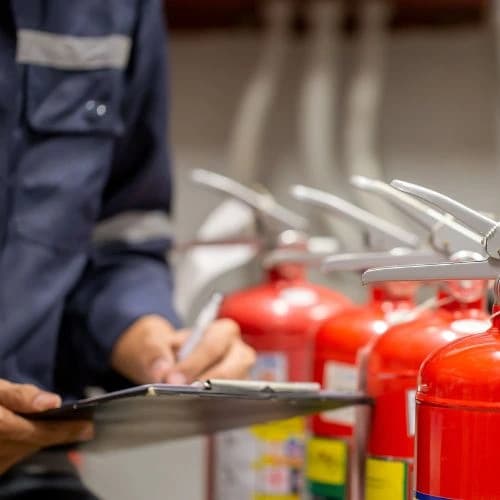 Fire Safety Expert examining Fire Extinguishers