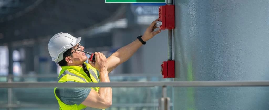 Fire Safety Expert examining fire alarm system