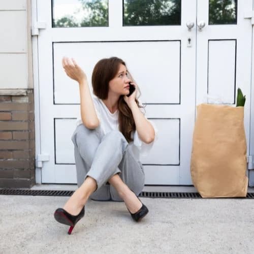 woman locked out of her house calling a locksmith